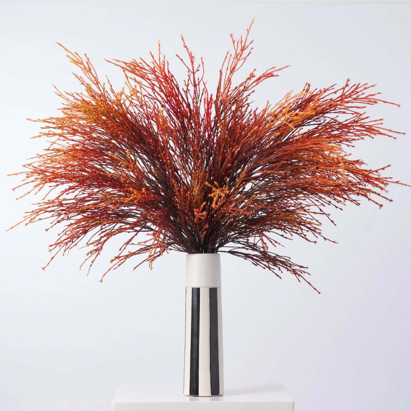 AR1623FieryPampasPlumes-OrangeYellowOmbreFountainGrassInBlackWhiteColumn Fiery Pampas Plumes - Orange Yellow Ombre Fountain Grass In Black White Column Vase - Image 1