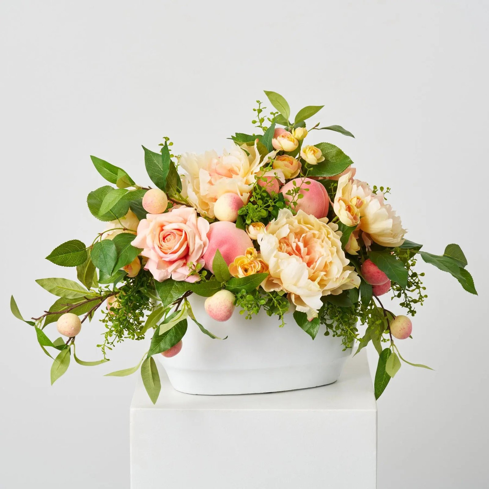 AR1838FeelingPeachyQueen-PeachPeonies_Roses_RealTouchGreenSalalLeaf_YellowPinkRanunculus_Fuzzy_1 Feeling Peachy Queen - Peach Peonies & Roses, Real Touch Green Salal Leaf, Yellow Pink Ranunculus & Fuzzy Peaches Spring Summer Centerpiece Arrangement in White Concrete Oval Pot - Image 1