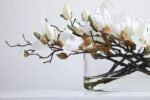 White or Fuchsia Magnolia Blooms Floral Centerpiece Water Illusion Arrangement in Oval Vase - Image 6