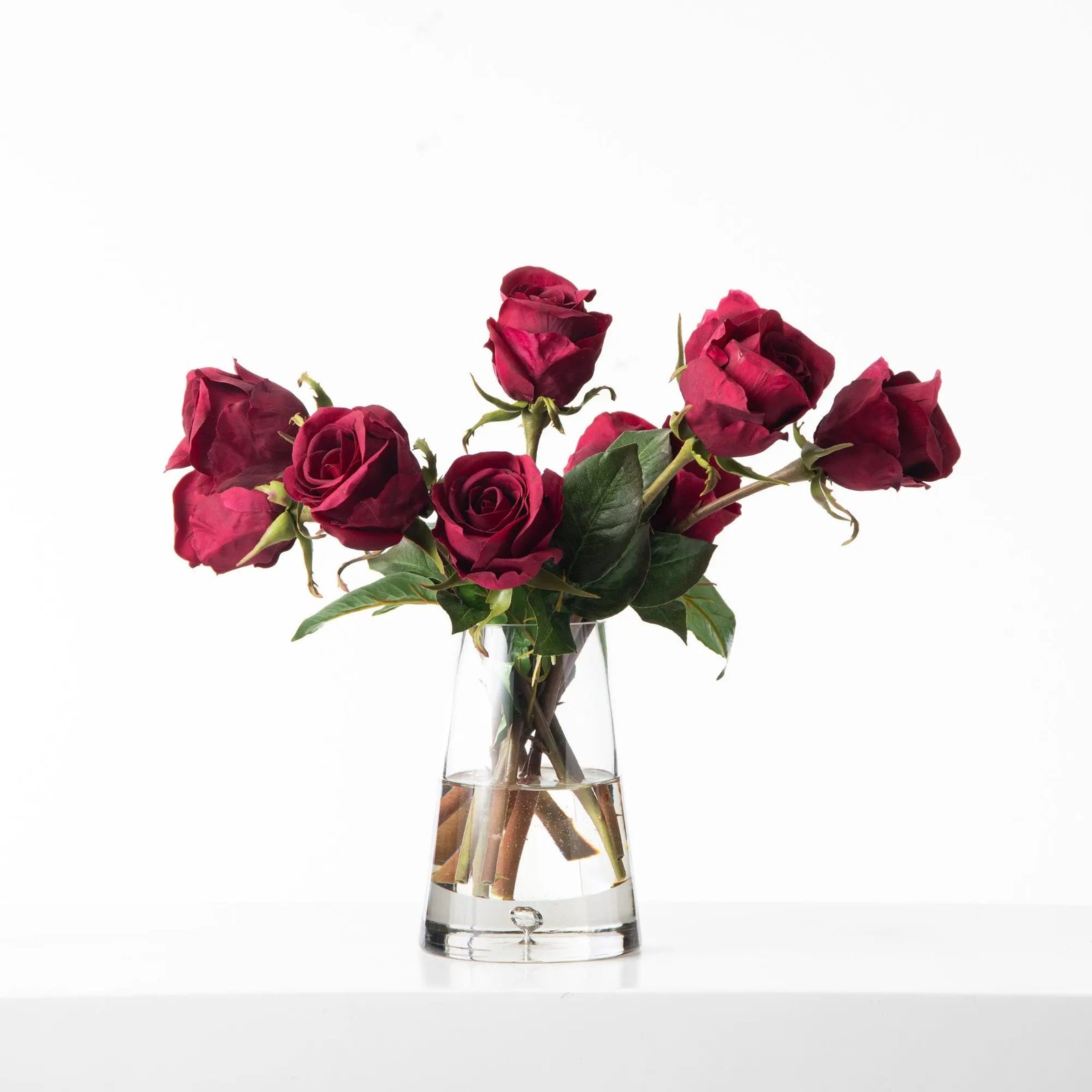 FAR1269RealTouchDarkRedBurgundyRoseBudsInTeardropPyramidGlassVaseWaterIllusionAllSeasonFloralArrangement_2 Real Touch Dark Red Burgundy Rose Buds In Teardrop Pyramid Glass Vase Water Illusion All Season Floral Arrangement - Image 1