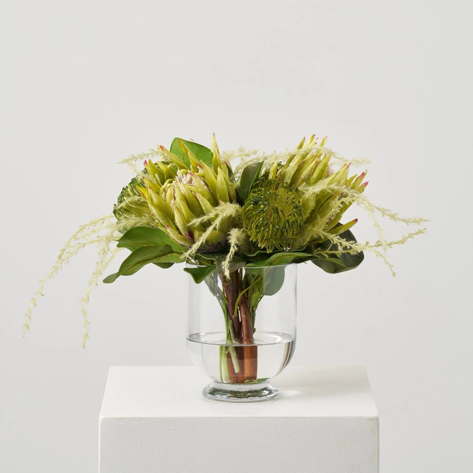 FAR1559ProteaParadise-LifelikeGreenKing_PincushionProteasinRoundedFootedVaseEverydayCenterpieceWaterIl_1 Protea Paradise - Lifelike Green King & Pincushion Proteas in Rounded Footed Vase Everyday Centerpiece Water Illusion Arrangement - Image 1