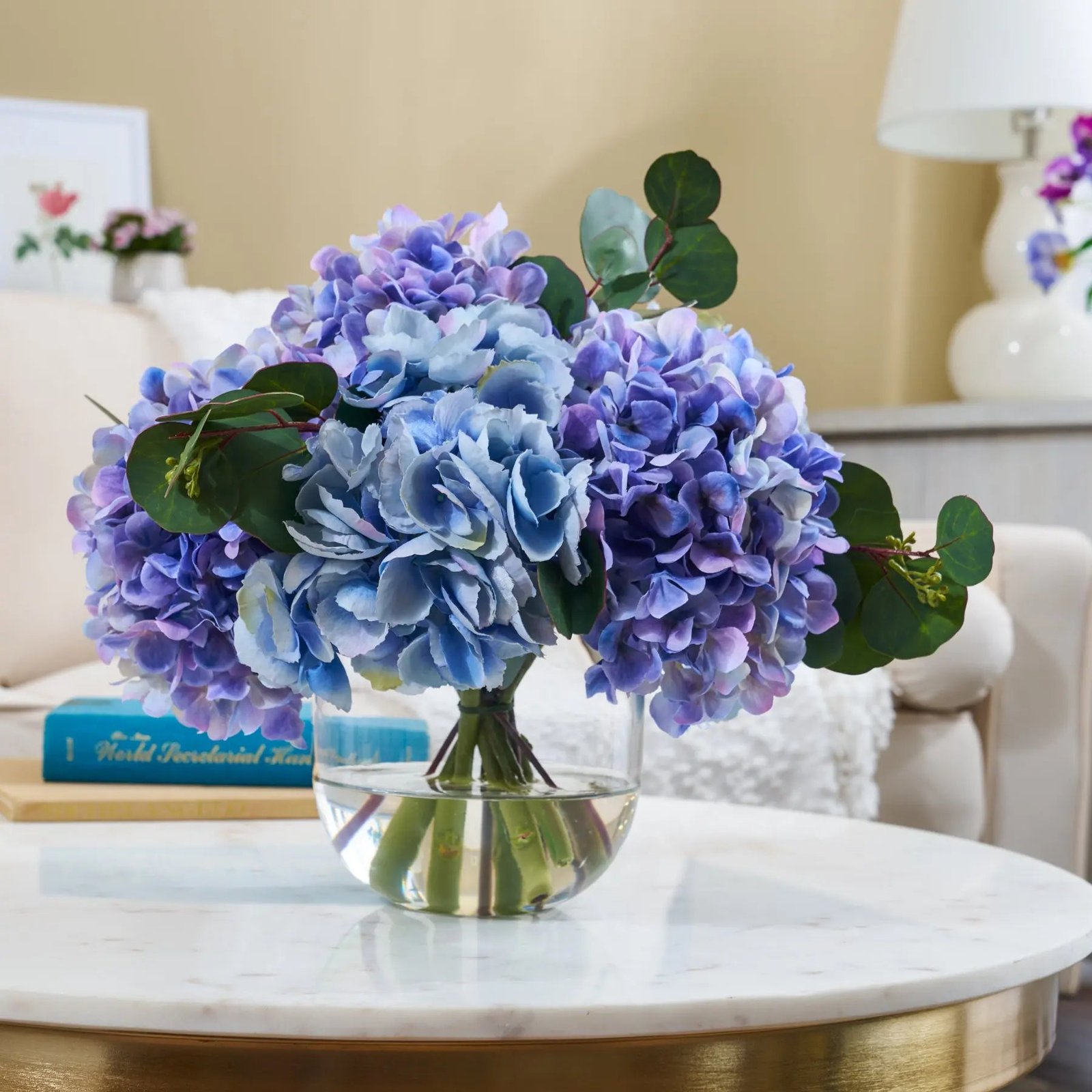 FAR1630Lifestyle Summer Hydrangea - Mixed Blue & Purple Large Blooms with Silver Dollar Eucalyptus Everyday Water Illusion Arrangement - Image 1
