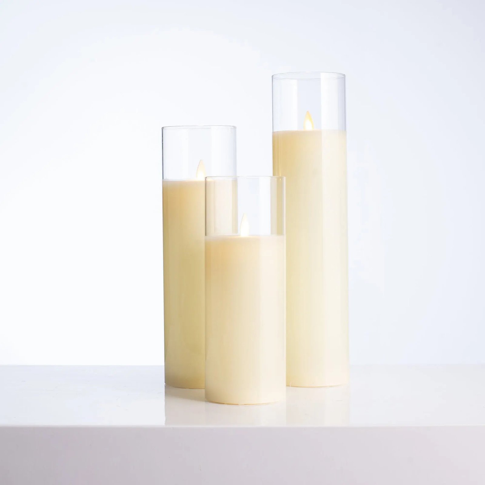 HMD1311TallMovingFlamelessLEDCreamGlassPillarCandleswithRemote-Setof3_1 Tall Moving Flameless LED Cream Glass Pillar Candles with Remote - Set of 3 - Image 1